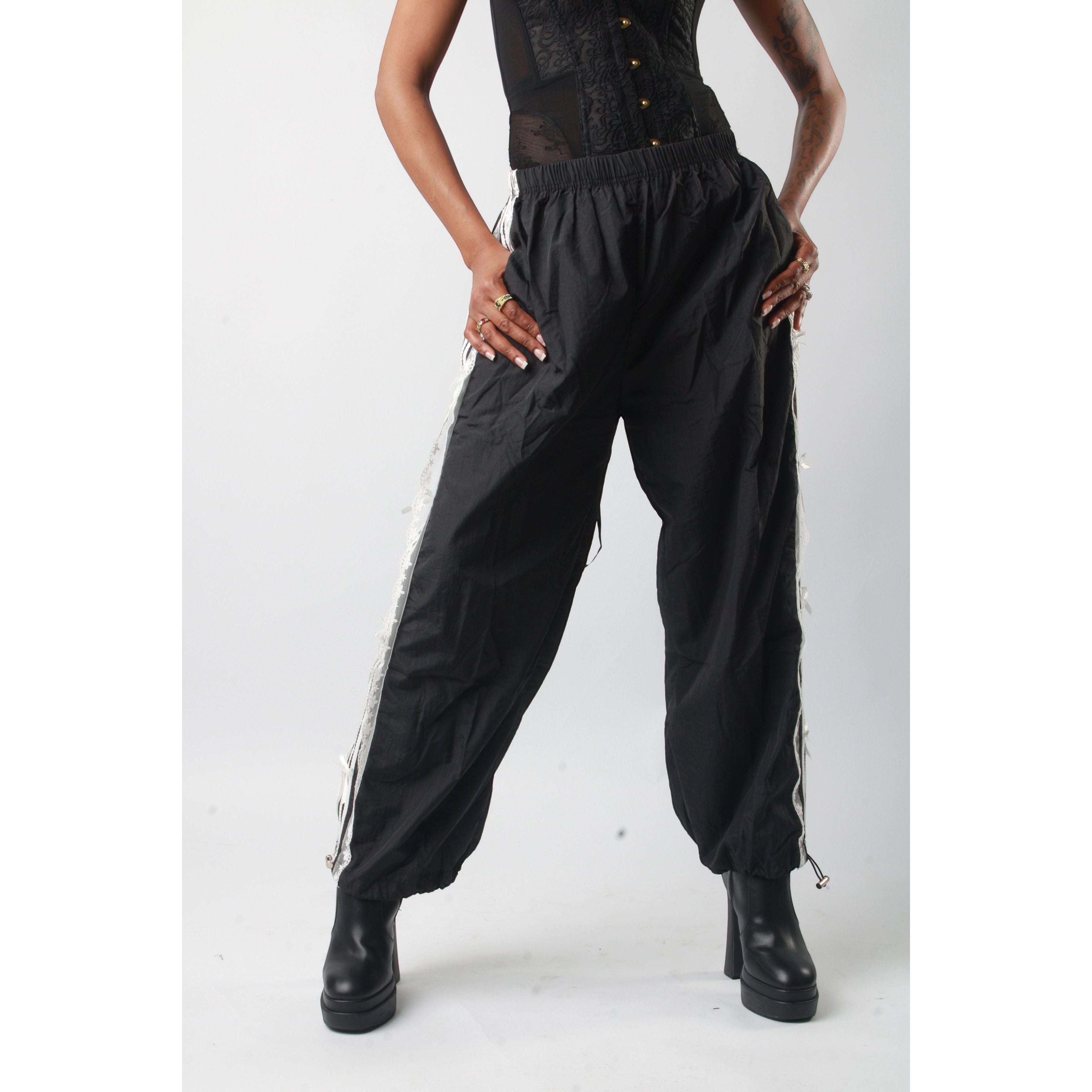 Sweet Plus Savage black track pants with lace trim detail and elastic waistband, tapered fit.