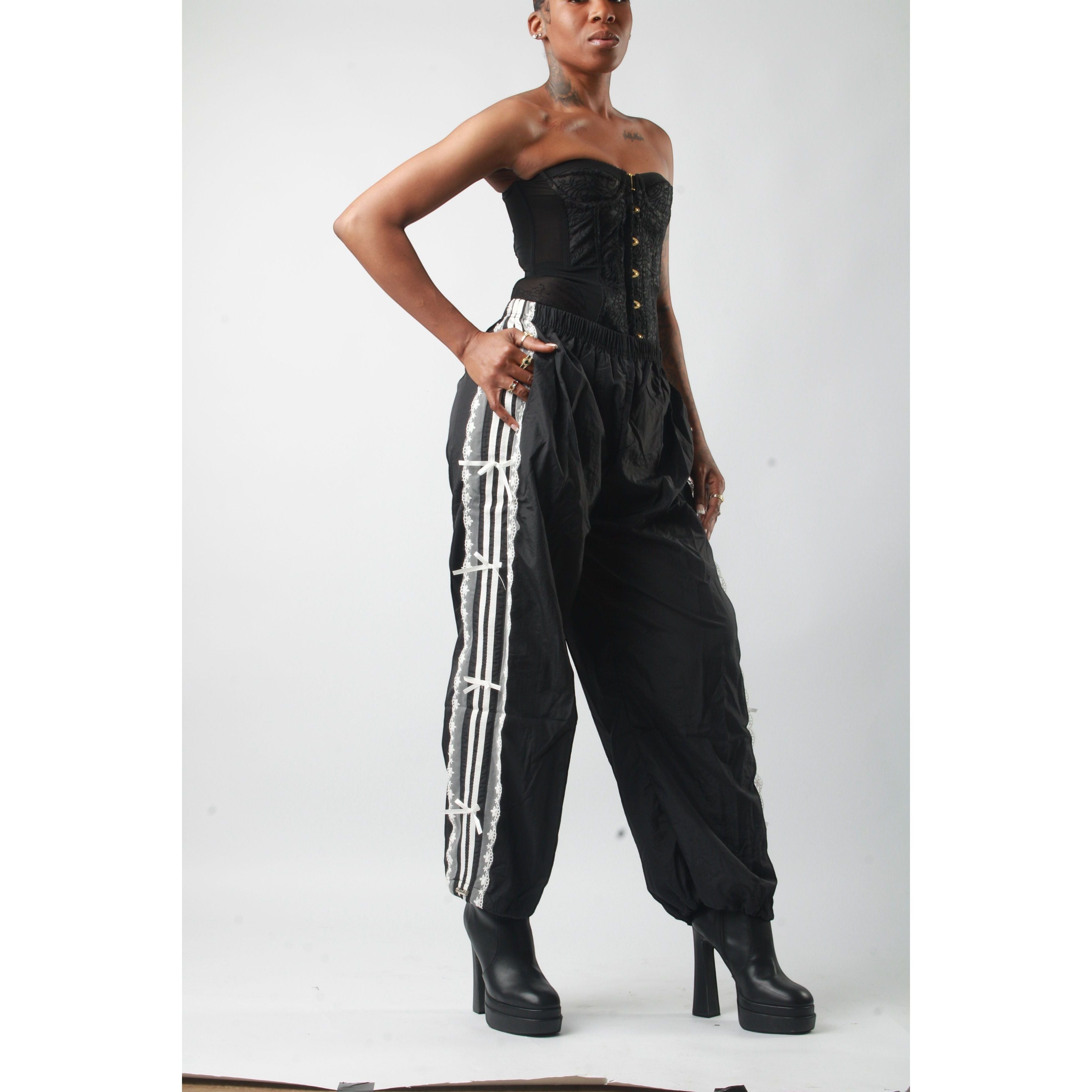 Sweet Plus Savage black track pants with lace trim down the side, elastic waistband, and tapered leg.