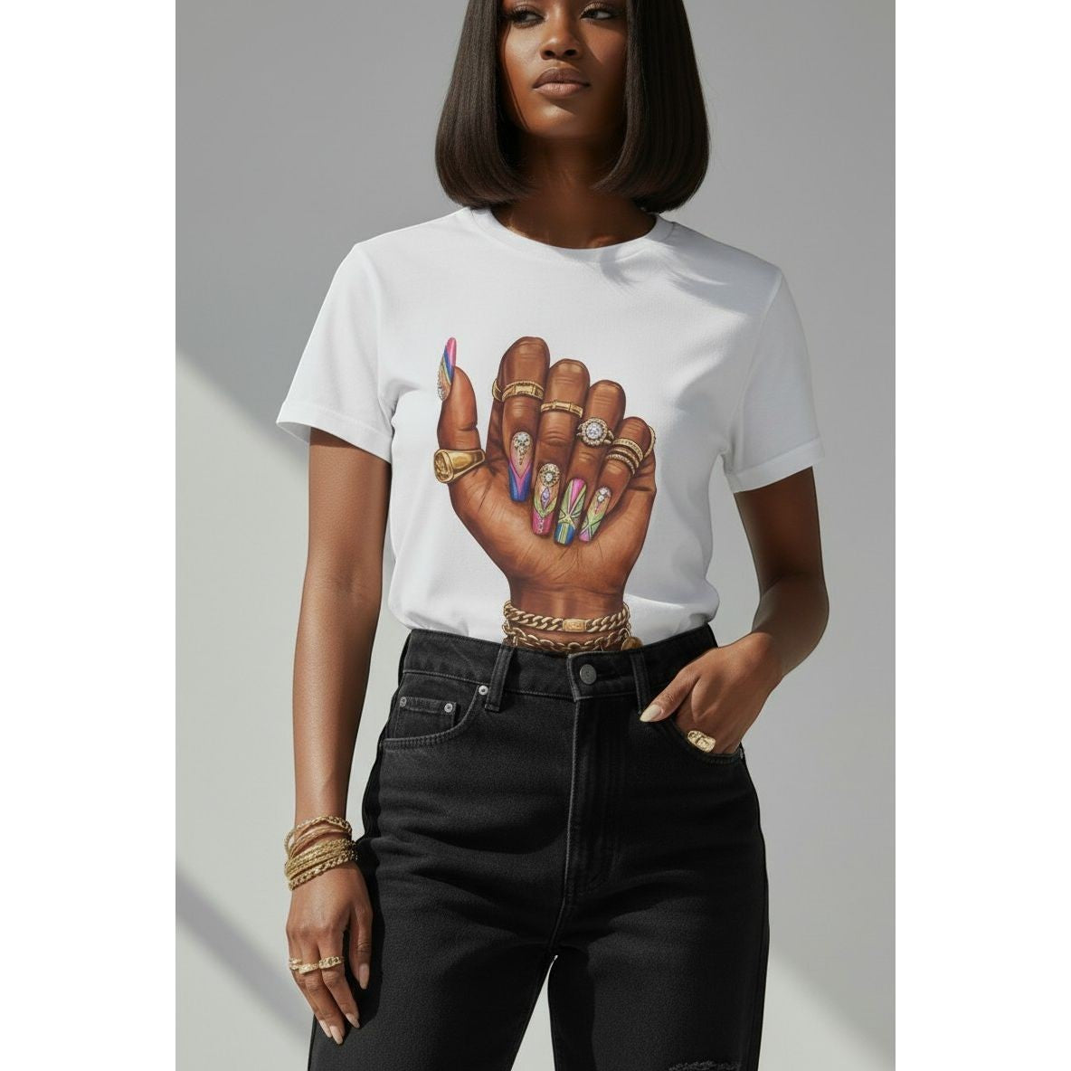 Sweet Plus Savage white cotton t-shirt with a graphic print of a woman's fist with long, colorful, jeweled nails and gold rings.