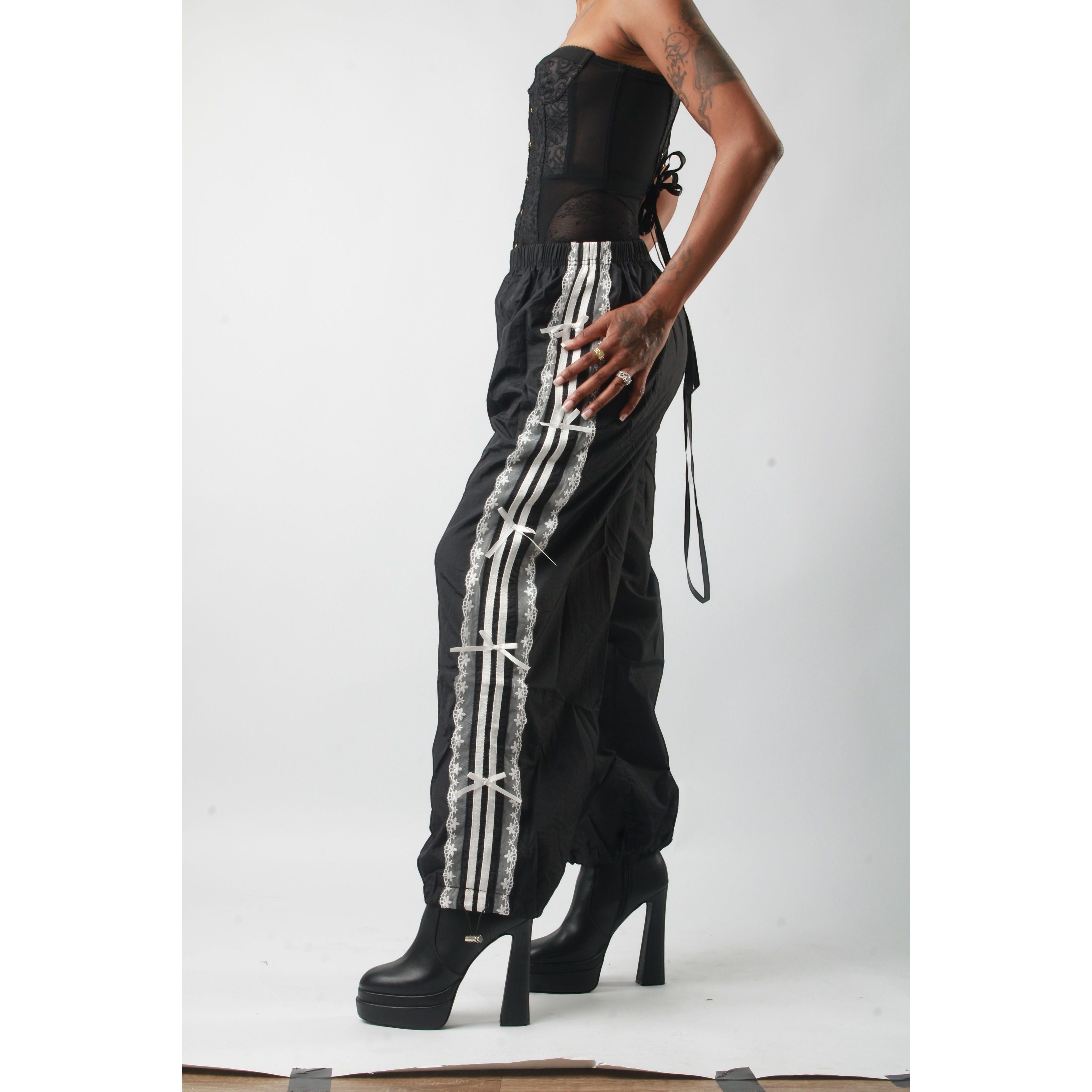Sweet Plus Savage black track pants with white lace trim and bows down the side. Relaxed fit with elastic waistband.