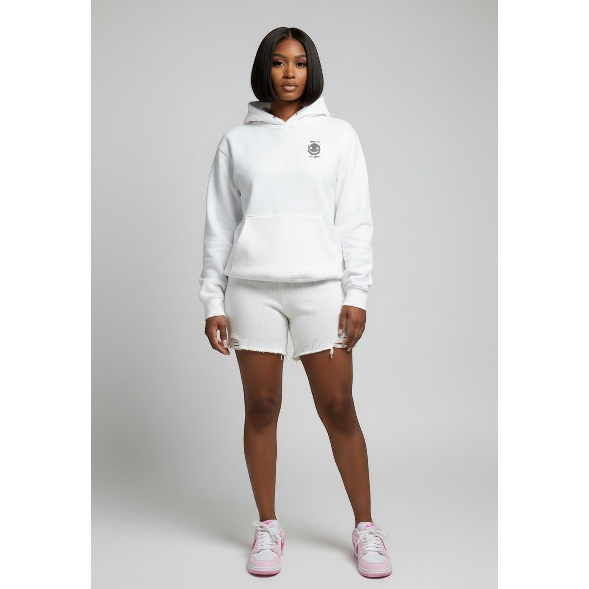 Sweet Plus Savage white graphic print hoodie with drawstring hood and kangaroo pocket, paired with distressed white shorts.